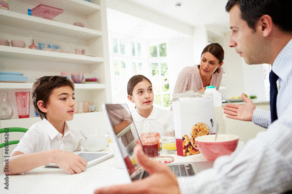 Family Using Digital Devices Having Argument Over Breakfast Family Using Digital Devices Having Argument Over Breakfast