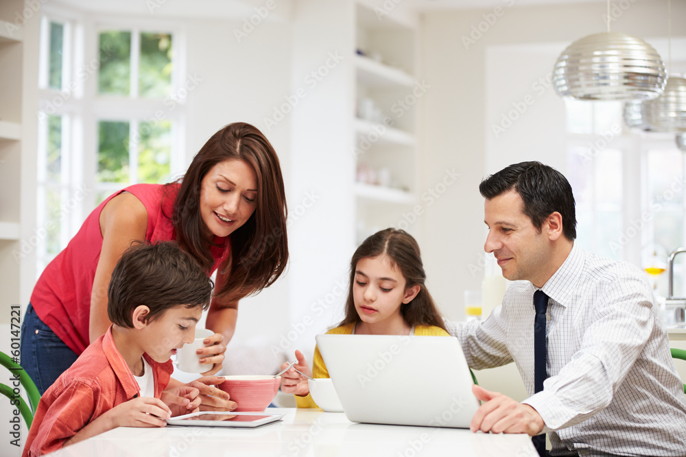 Family Using Digital Devices At Breakfast Table Family Using Digital Devices At Breakfast Table