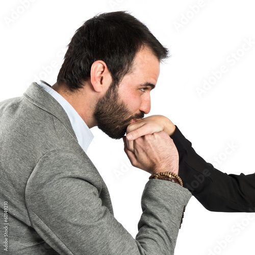 man kissing a woman's hand over white background.