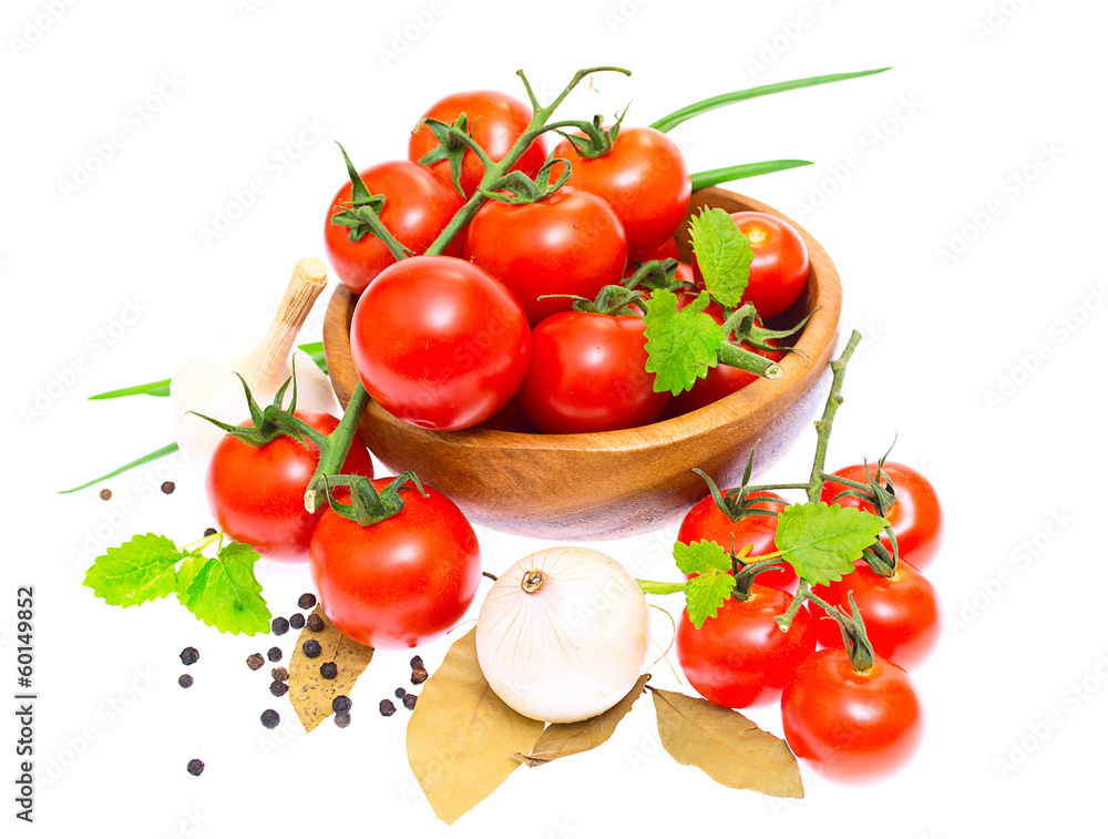 The branch of cherry tomatoes in a wooden bowl, onion, garlic, b The branch of cherry tomatoes in a wooden bowl, onion, garlic, b