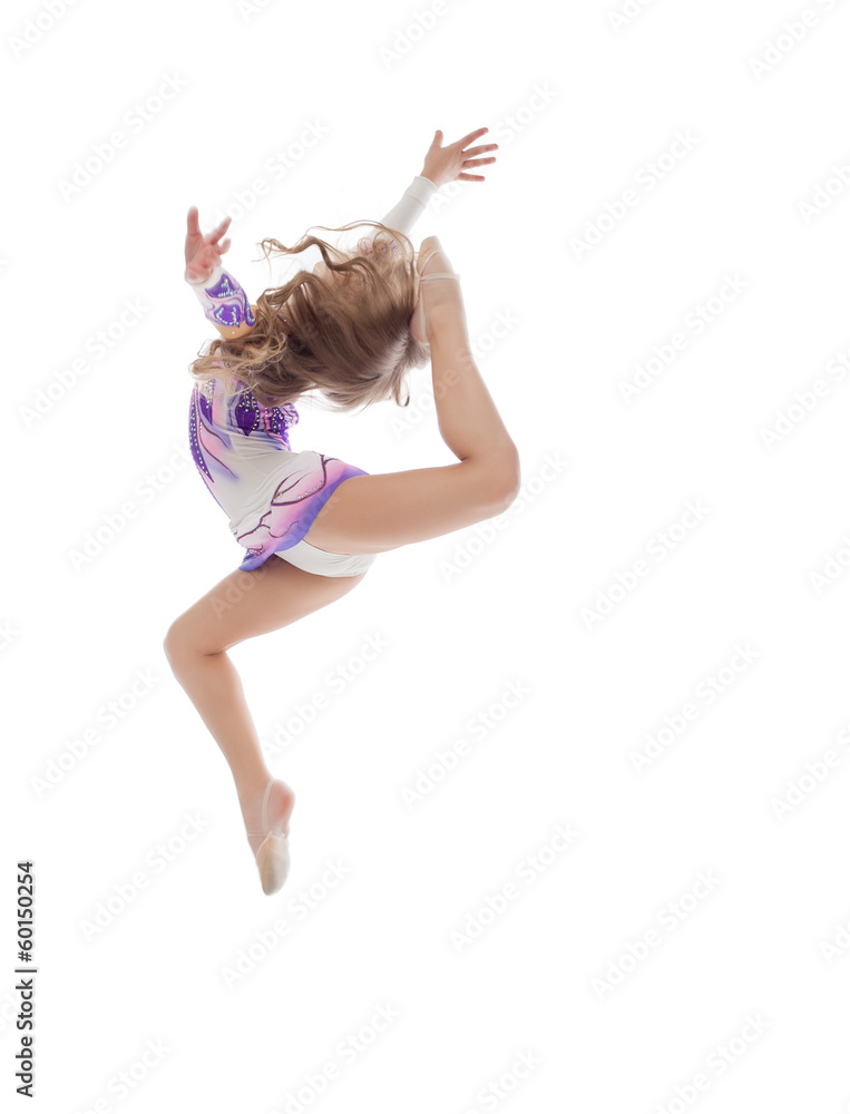 Fototapeta premium Graceful little artistic gymnast posing in jump