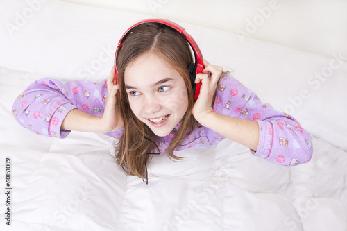 Happy smiling girl with headphones listening to music