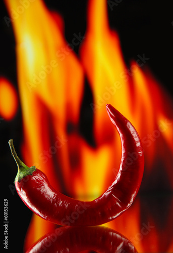 Red hot chili peppers on fire background