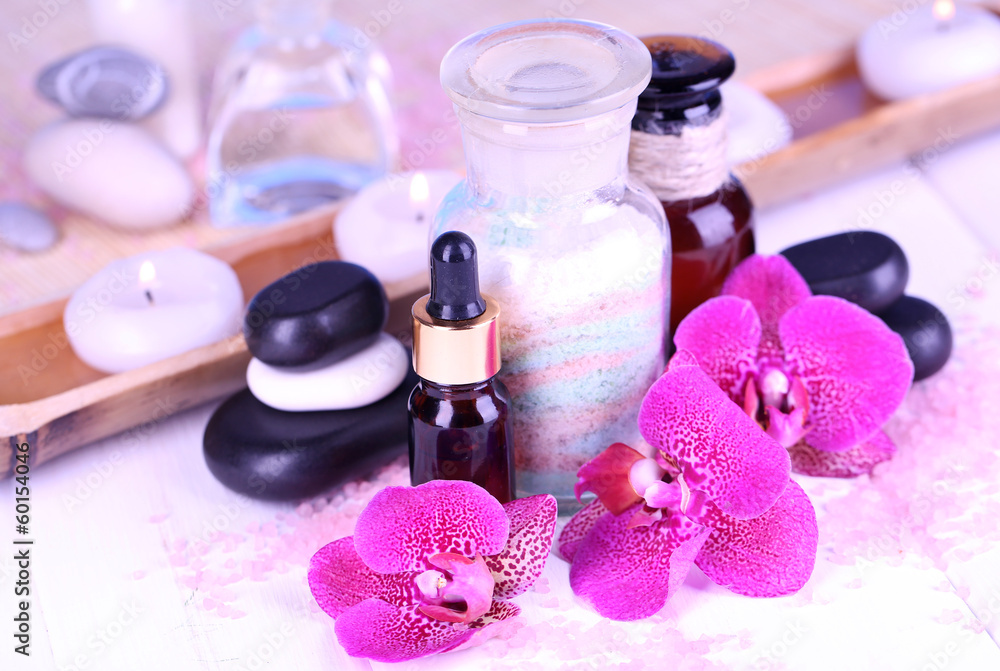 Beautiful spa setting with orchid on white wooden table Beautiful spa setting with orchid on white wooden table