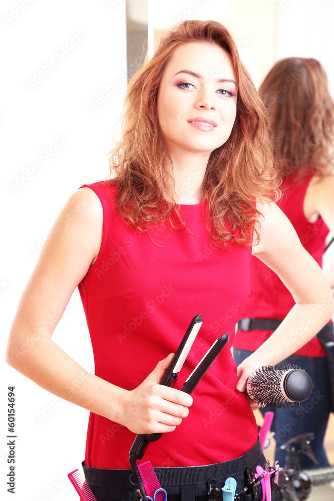 Fototapeta premium Beautiful girl hairdresser in beauty salon