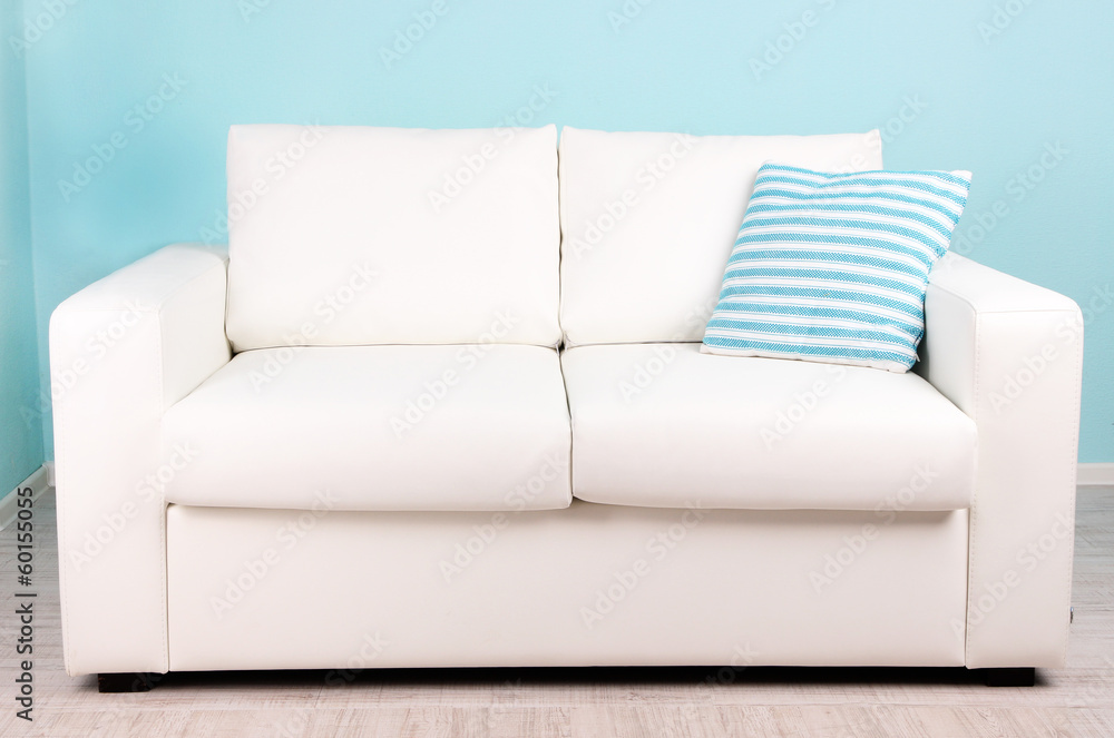 White sofa in room on blue background White sofa in room on blue background