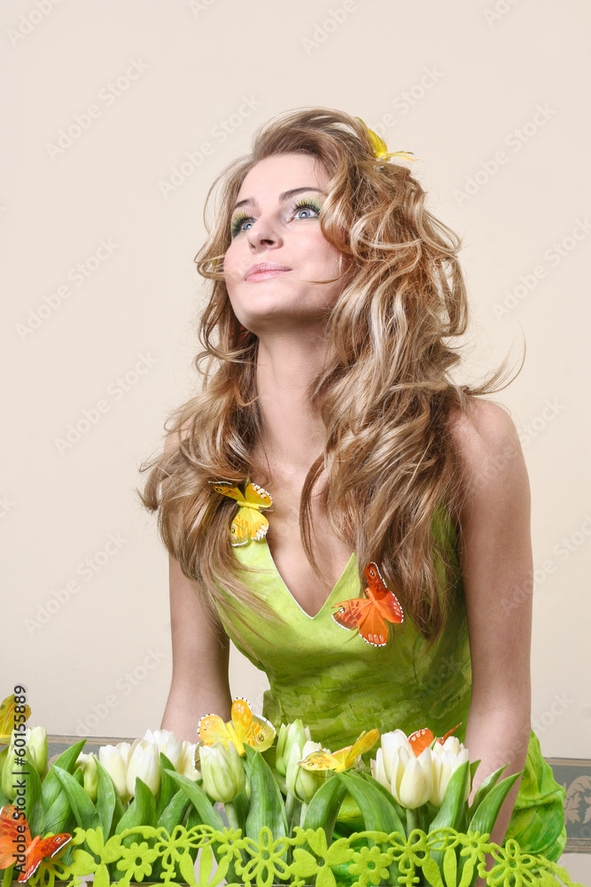 Naklejka premium Beautiful spring girl with butterflies in her hair. Copy space