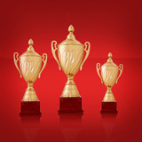 Three gold trophies on bright yellow background