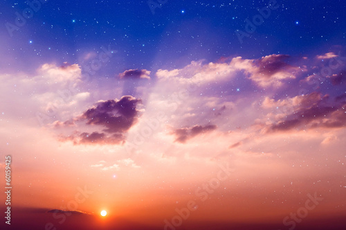 Sunset with sun, clouds and stars.