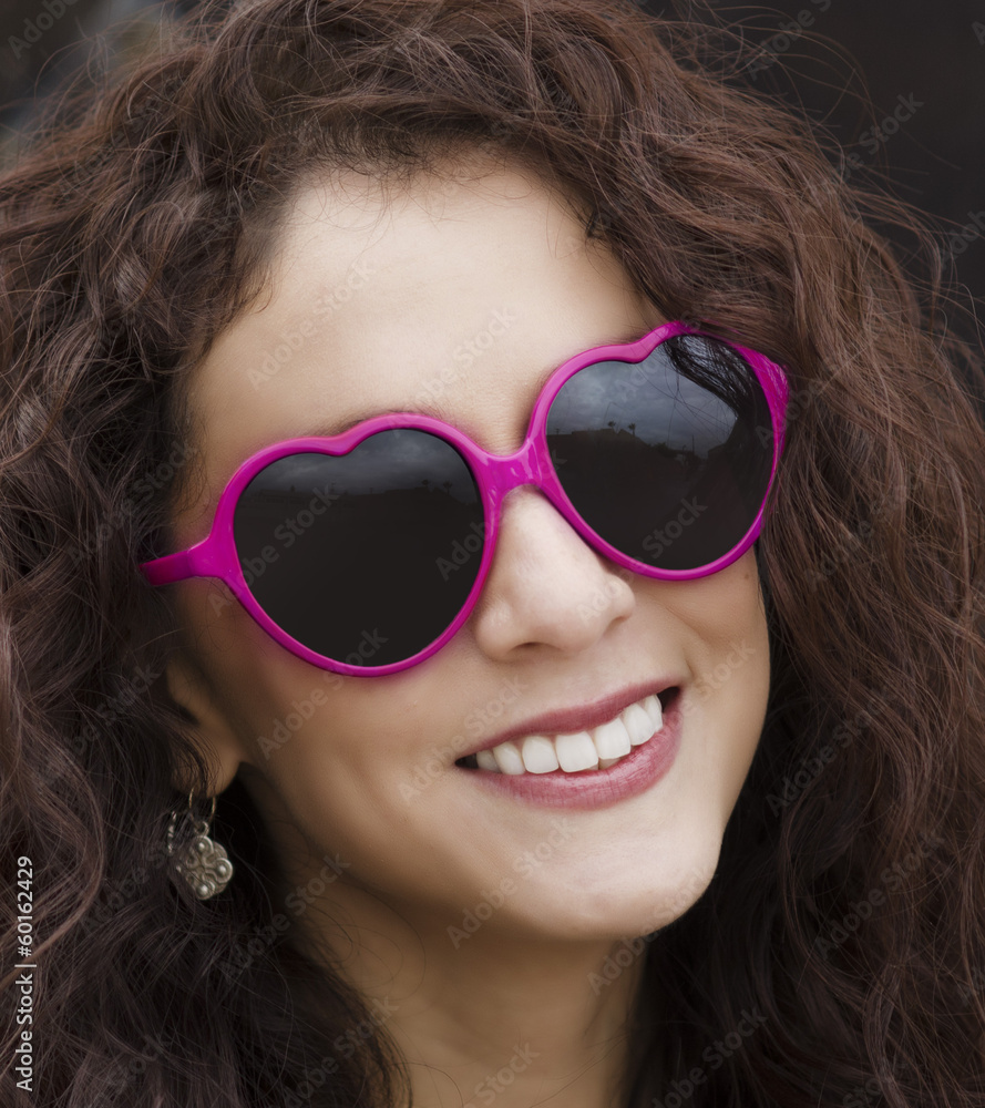 Happy playful smiling woman wearing sunglasses Happy playful smiling woman wearing sunglasses