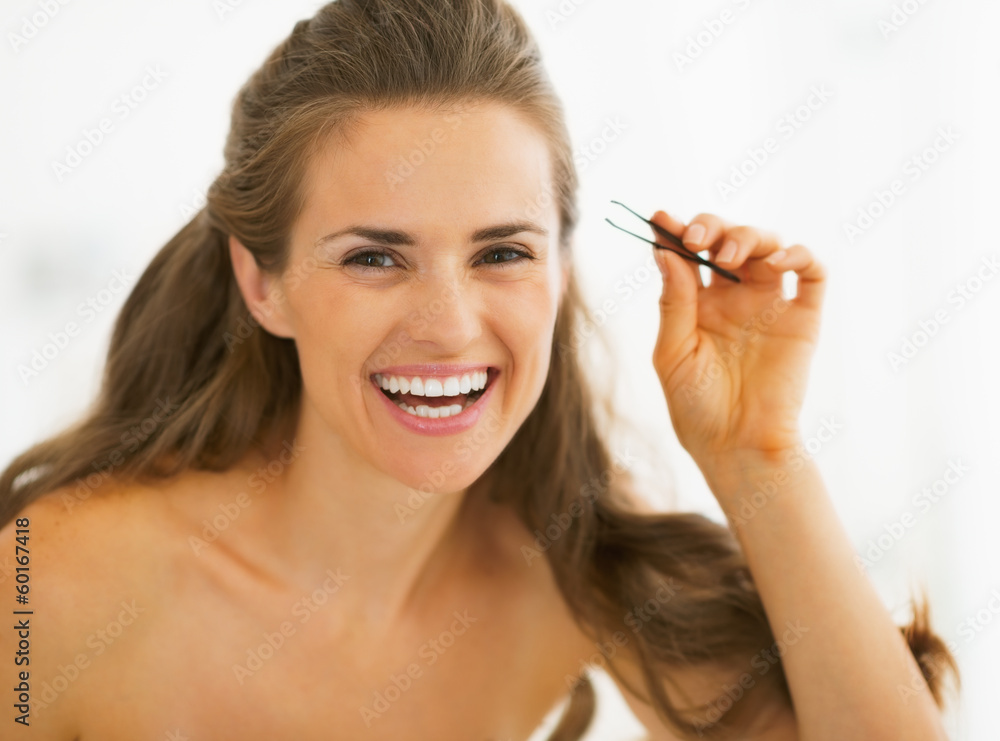 Happy young woman with tweezers Happy young woman with tweezers
