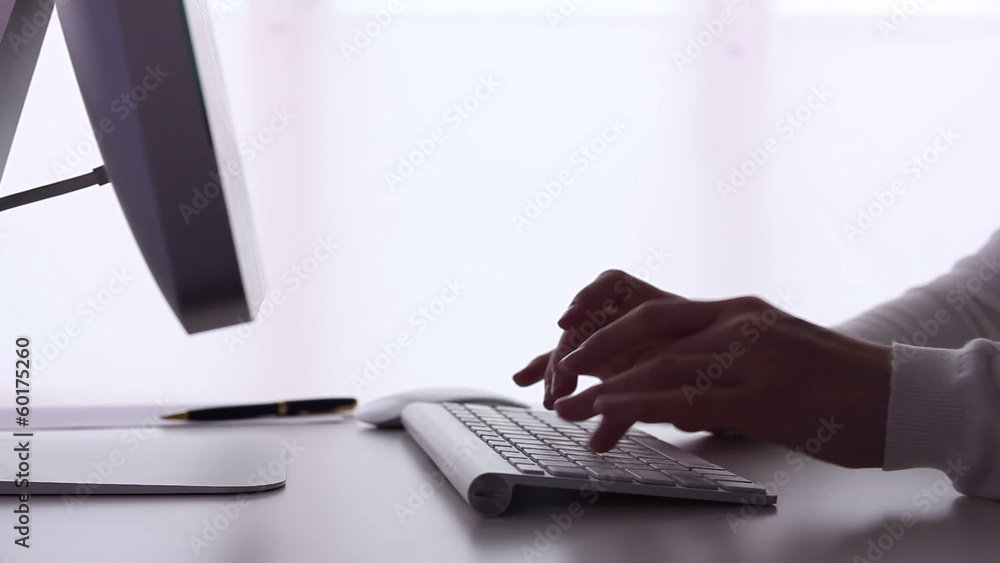 Woman typing on a computer. Woman typing on a computer.