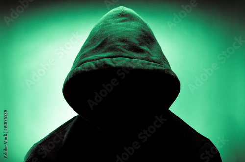 Man wearing hood with face in shadow