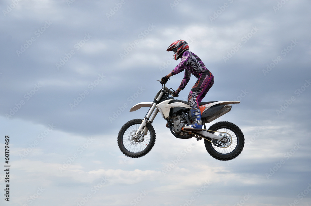 MX participant on a motorcycle in the air MX participant on a motorcycle in the air