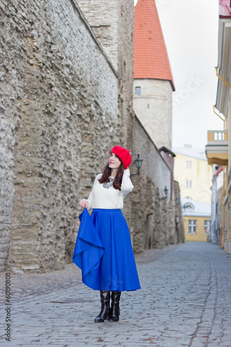 attractive woman walking in ancient town of Tallinn, Estonia