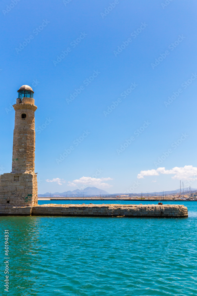Old venetian lighthouse at harbor. Rethymno, Crete, Greece