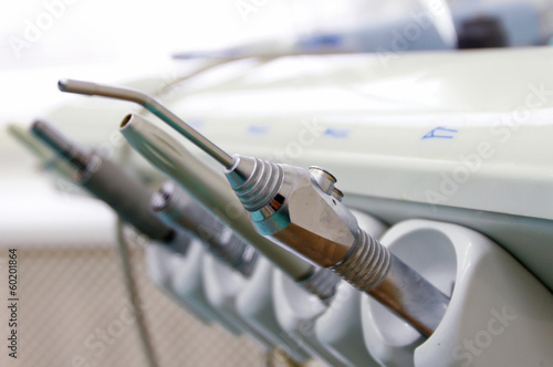 Dental tools on a dentist's chair.