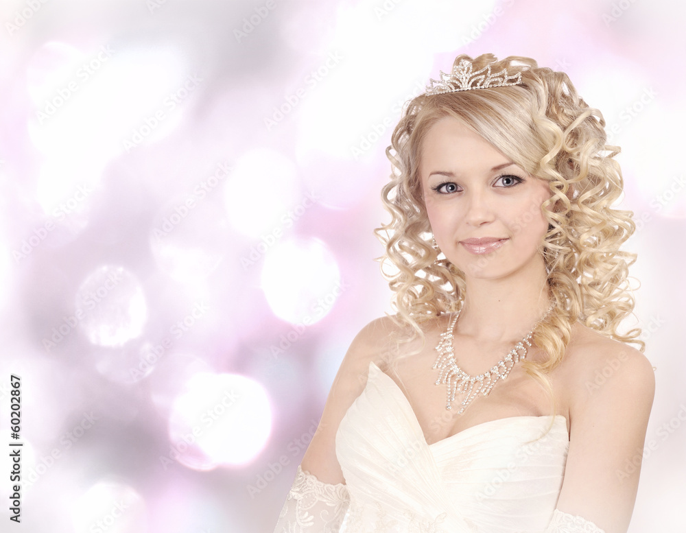 Smiling young bride on light bokeh  background.