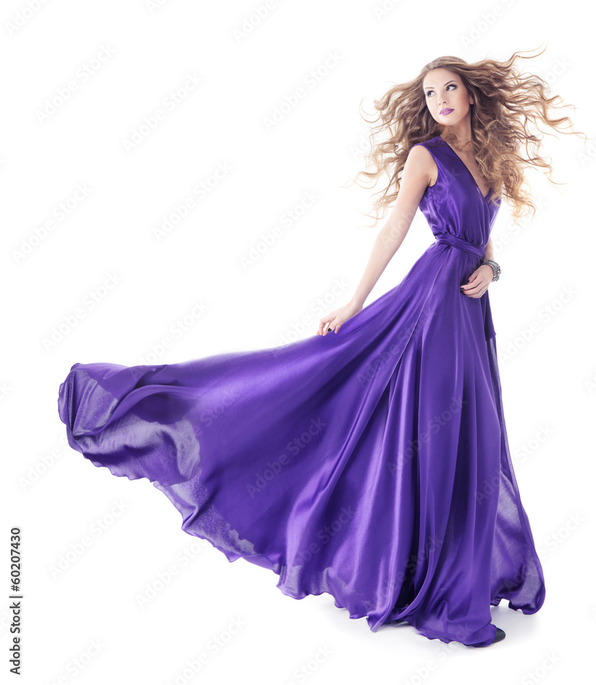 Woman in purple silk waving dress walking over white background Woman in purple silk waving dress walking over white background