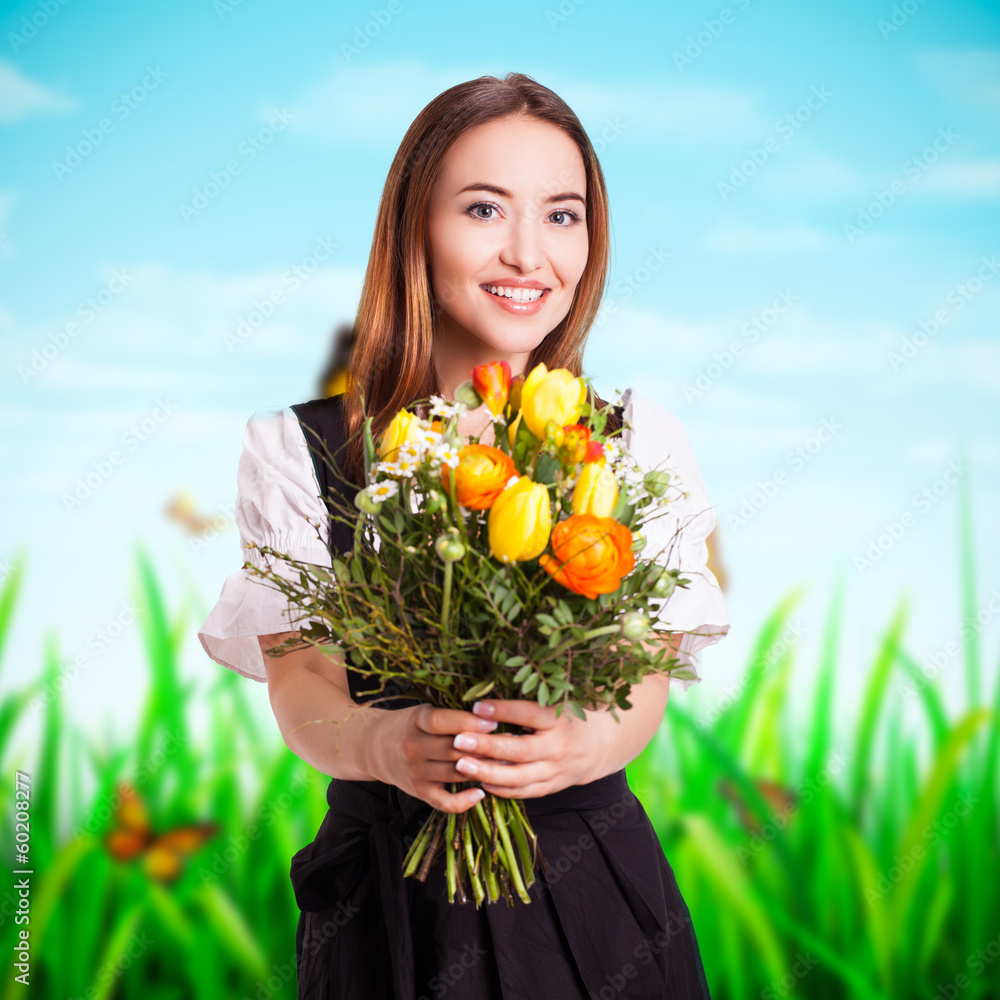 junge Frau im Dirndl mit Blumenstrauß - obrazy, fototapety, plakaty 