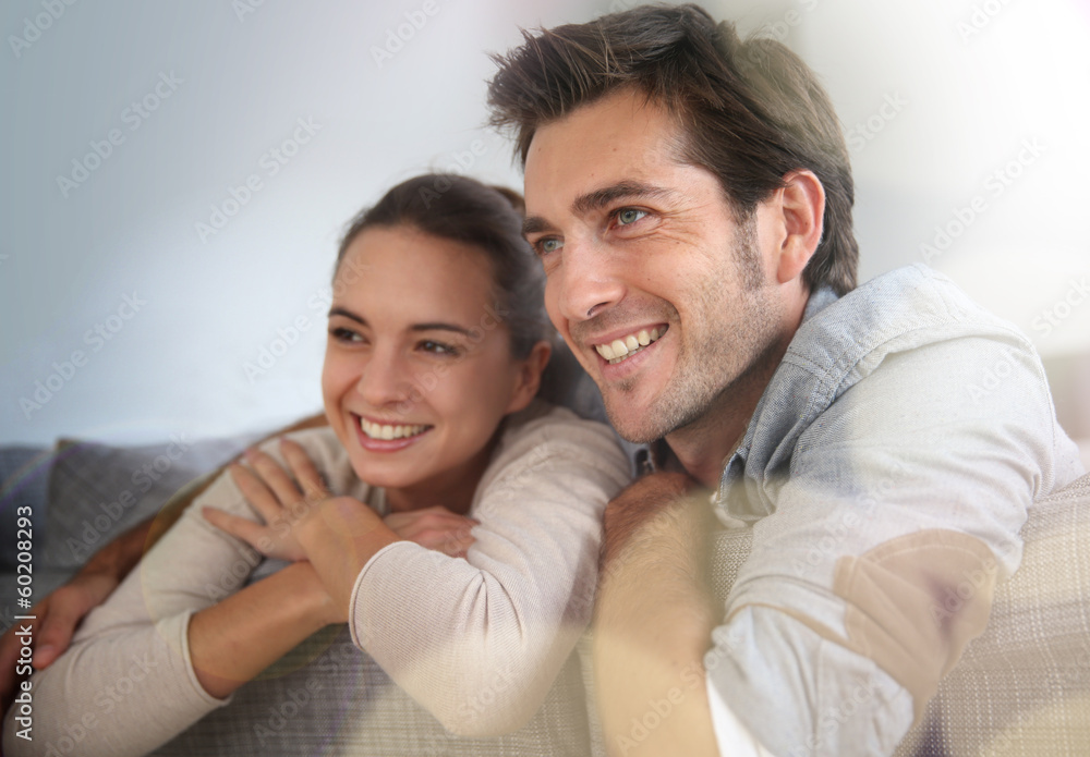 Couple at home relaxing in sofa