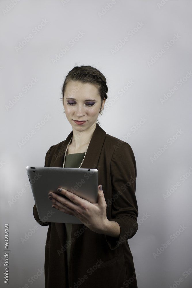 Fototapeta premium Pretty young business woman holding tablet