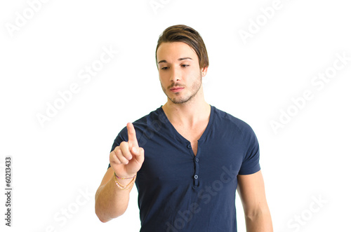 Fotografie Handsome young man pressing imaginary button