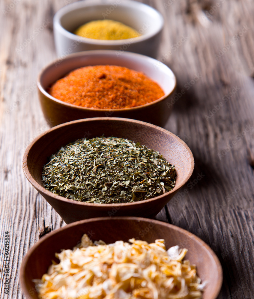 Assorted spices on wooden background Assorted spices on wooden background