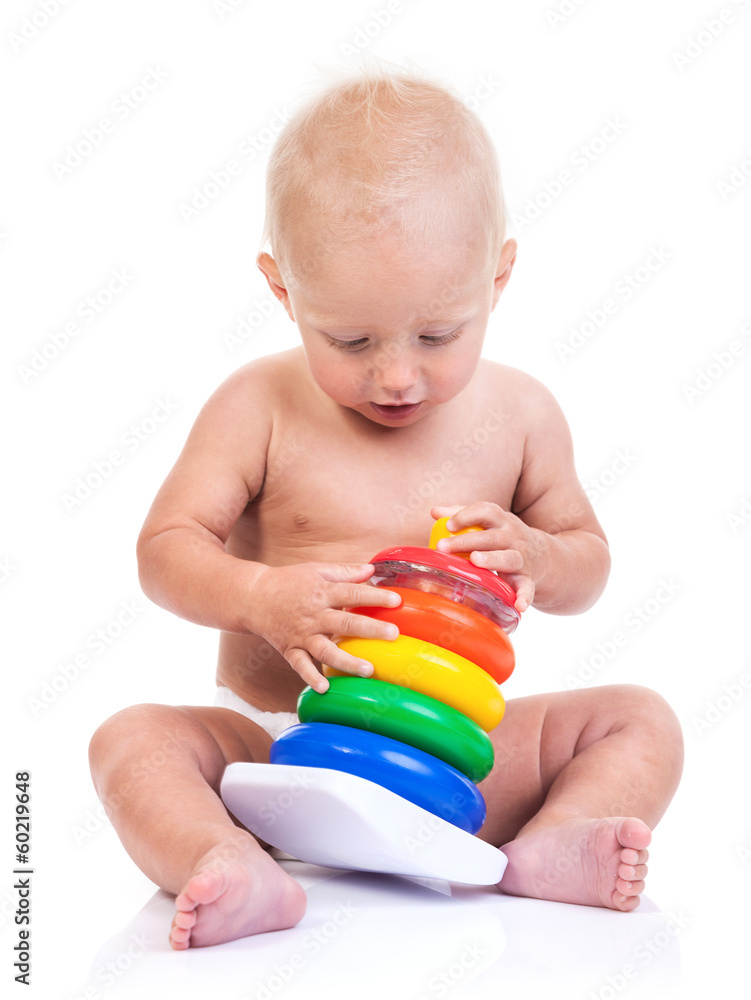Cute little boy playing with pyramid toy over white Cute little boy playing with pyramid toy over white