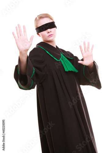 Lawyer attorney in polish gown covering eyes with blindfold