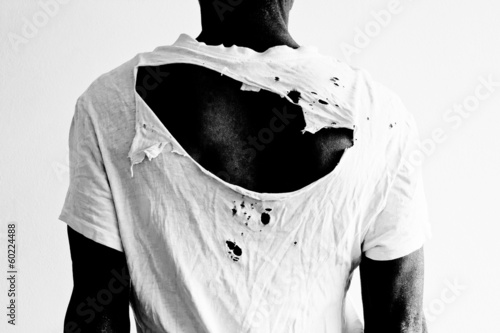 man's back with ripped t-shirt
