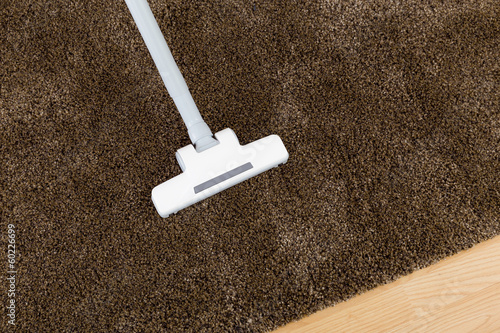 Brown carpet with vacuum cleaner photo