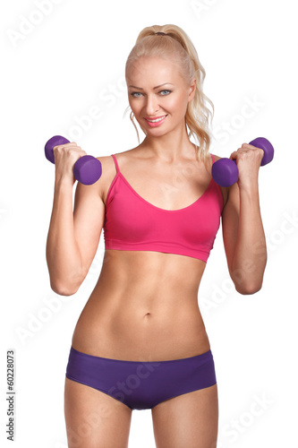 Young beautiful woman in fitness wear with dumbbells