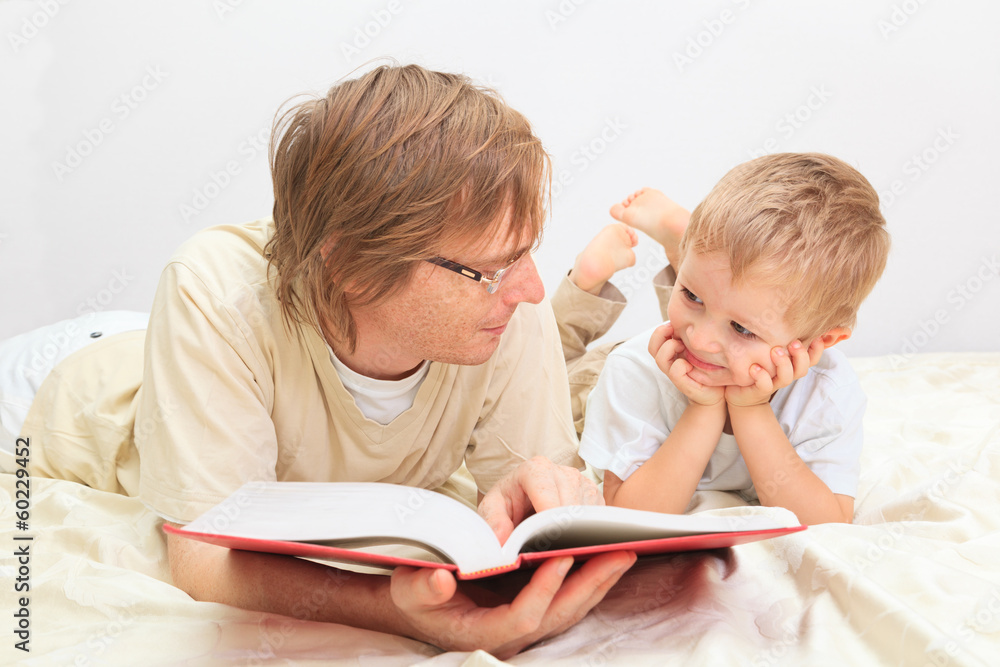 Father and son reading together Father and son reading together