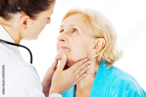 Doctor Examining Senior Woman s Throat
