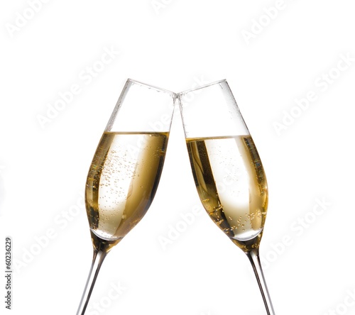champagne flutes with golden bubbles make cheers on white