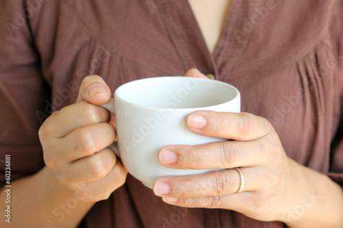coffee cup in woman hand.