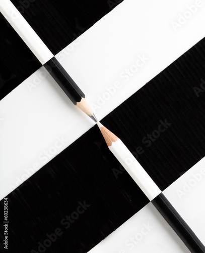 Canvas Print white pencil and black pencil placed on opposite color