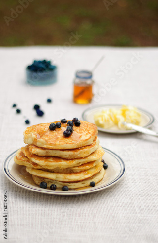 Blueberry pancakes with butter and honey