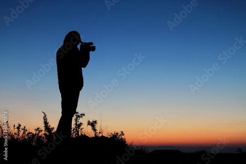 The Cameraman, Silhouette of Man with Video Camera at Sunset © jasastyle