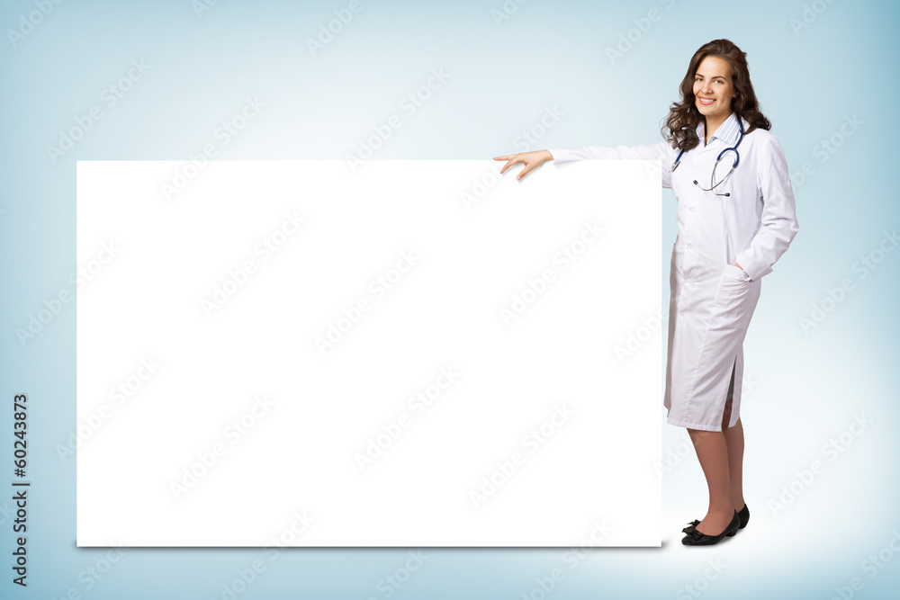 young woman doctor standing near a blank banner young woman doctor standing near a blank banner