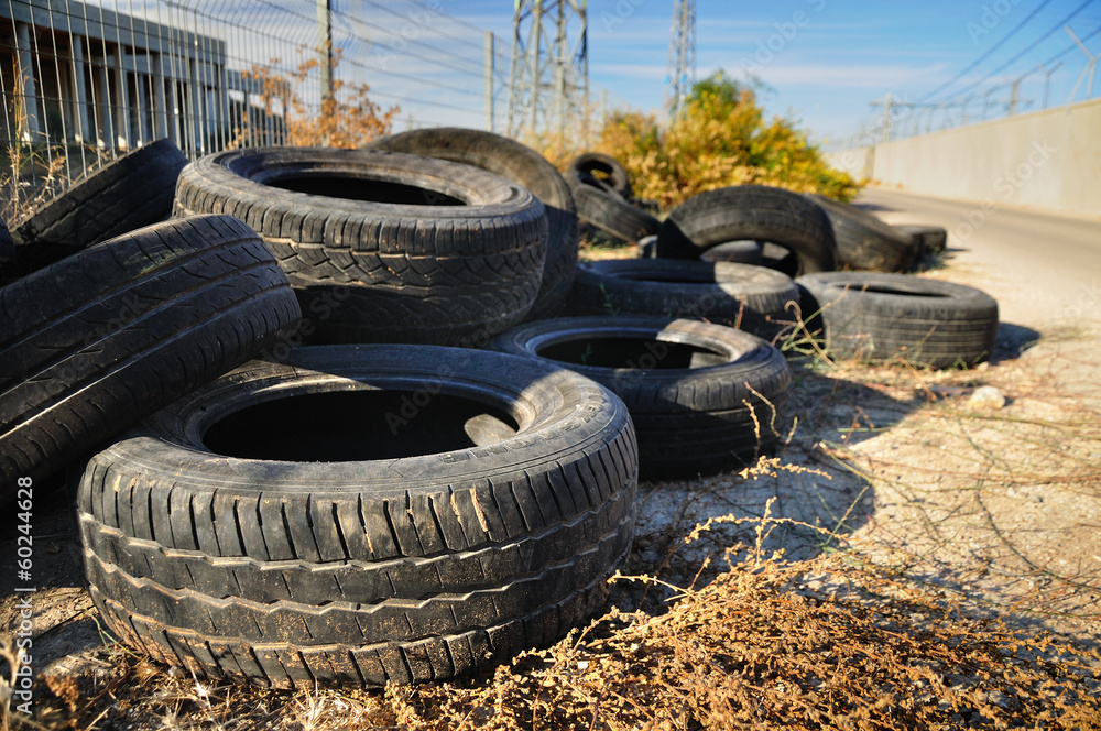 Pile of used tires in industrial zone .