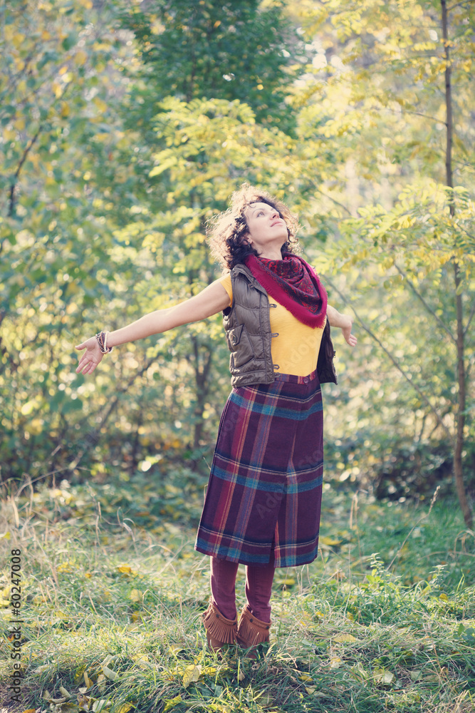 Beautiful smiling woman in bright clothes in the park Beautiful smiling woman in bright clothes in the park