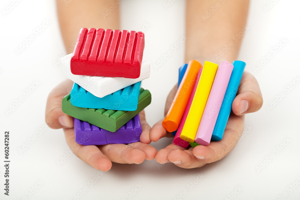 Child hands with colorful modeling clay Child hands with colorful modeling clay