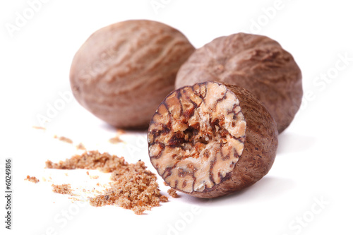 half and whole nutmegs isolated on a white background closeup