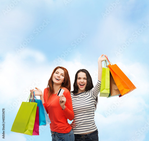 teenage girls with shopping bags and credit card