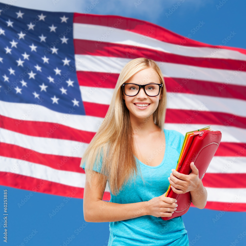 smiling student in eyeglasses with folders smiling student in eyeglasses with folders
