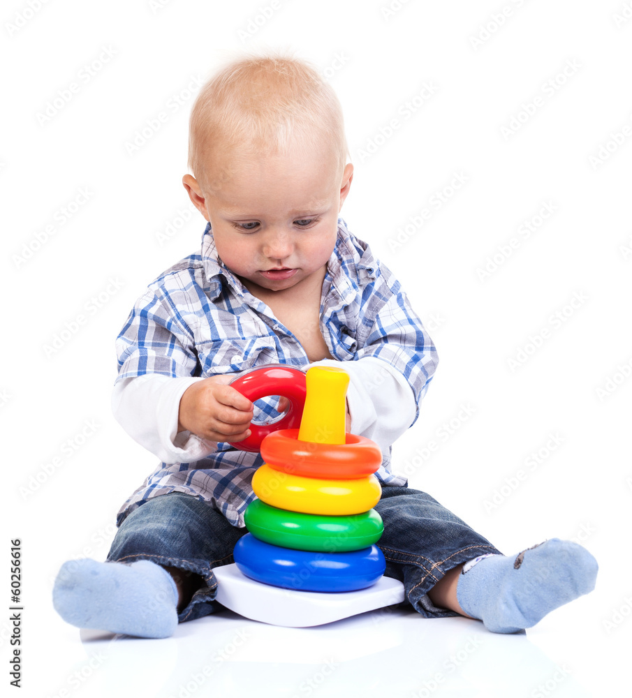 Cute little boy playing with pyramid toy over white Cute little boy playing with pyramid toy over white