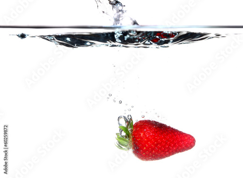 strawberry in the water splash over white