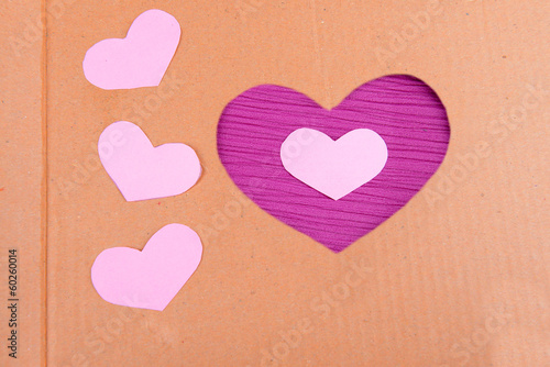 Cardboard heart on purple background
